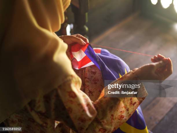 women sewing national flag - malaysia flag stock pictures, royalty-free photos & images