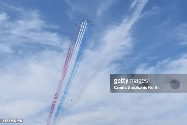 The Royal Air Force Red Arrows release their signature red, white and blue smoke during a flyover the Hudson River on August 22, 2019 in New York...