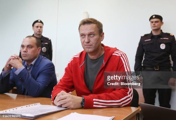 Alexey Navalny, Russian opposition leader, second right, reacts during a hearing at the Simonovsky District Court in Moscow, Russia, on Thursday,...