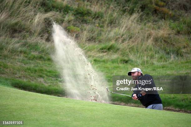 Holmes of the United States hits his third shot from the bunker on the seventh hole during the third round of the 148th Open Championship held on the...