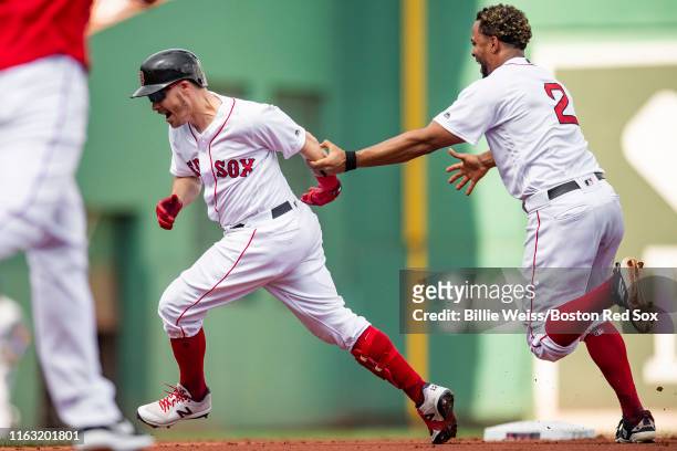 Brock Holt of the Boston Red Sox reacts after hitting a game winning walk-off RBI single during the tenth inning of a game against the Kansas City...
