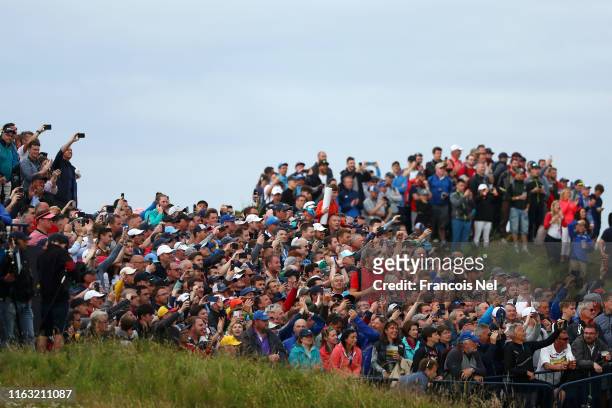The crowd enjoy the atmosphere during the third round of the 148th Open Championship held on the Dunluce Links at Royal Portrush Golf Club on July...