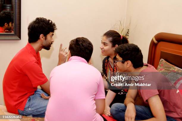 a group of young people discussing and enjoying together - pakistan family stock pictures, royalty-free photos & images