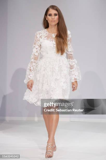 Cathy Hummels walks the runway at the Unique Fashion Show Spring-Summer 2020 at Oceandiva on July 20, 2019 in Dusseldorf, Germany.