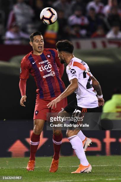 Oscar Ruiz of Cerro Porteño fights for the ball with Milton Casco of River Plate during a match between River Plate and Cerro Porteño as part of...