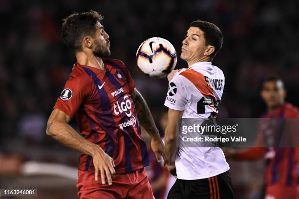Joaquin Larrivey of Cerro Porteño fights for the ball with Ignacio Fernandez of River Plate during a match between River Plate and Cerro Porteño as...