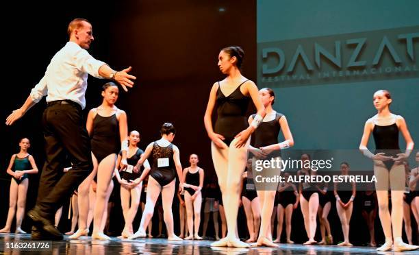 Polish choreographer and Deputy Artistic Director at the Berlin State Ballet School, Marek Rozycki gives instructions to Mexican teen dancers during...