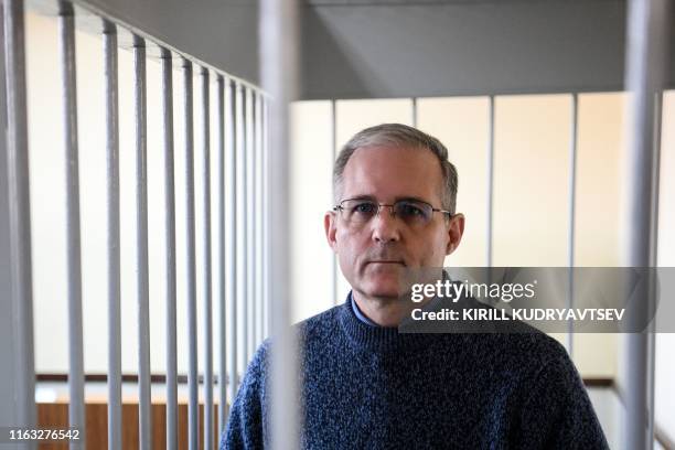 Paul Whelan, a former US Marine accused of spying and arrested in Russia stands inside a defendants' cage during a hearing at a court in Moscow on...