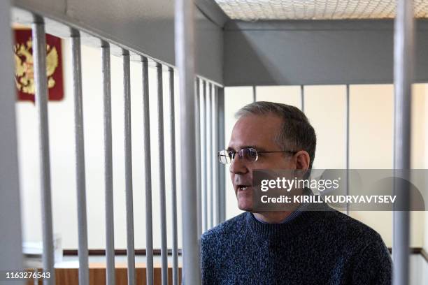 Paul Whelan, a former US Marine accused of spying and arrested in Russia stands inside a defendants' cage during a hearing at a court in Moscow on...