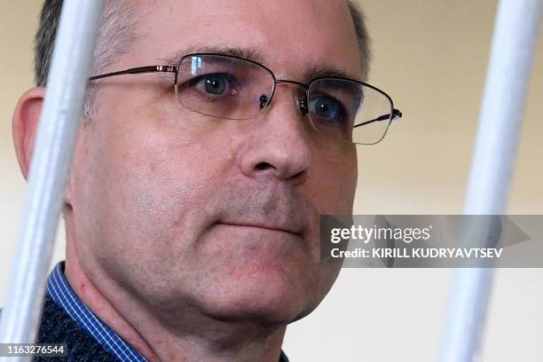 Paul Whelan, a former US Marine accused of spying and arrested in Russia stands inside a defendants' cage during a hearing at a court in Moscow on...