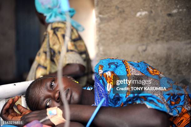 South Sudanese woman lays in bed on April 2 at a health clinic in Terekeka, 82 km north of Juba, an area where the population is exposed to malaria,...