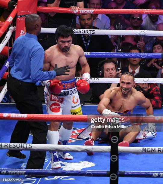 Referee Kenny Bayless steps in after Manny Pacquiao knocked Keith Thurman down in the first round of their WBA welterweight title fight at MGM Grand...