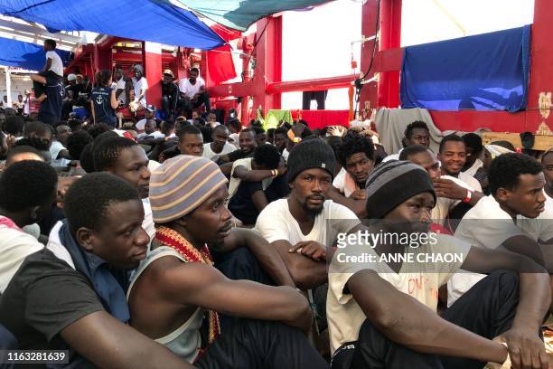 Rescued migrants gather aboard the 'Ocean Viking' rescue ship, jointly operated by French NGOs SOS Mediterranee and Medecins sans Frontieres on...