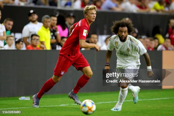 Fiete Arp of Bayern Muenchen baattles for the ball with Marcelo of Real and his team mate Eden Hazard during the International Champions Cup match...