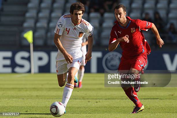 Javi Martinez of Spain is tracked by Jan Lecjaks during the UEFA European Under-21 Championship Group B match between Czech Republic and Spain at the...