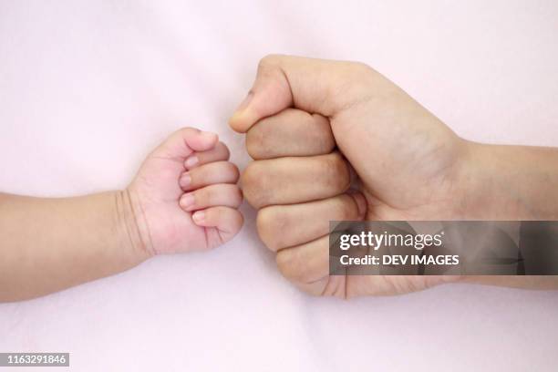 fist of mother and baby close up - kid punching stock pictures, royalty-free photos & images