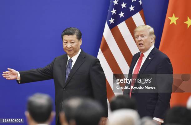 President Donald Trump and his Chinese counterpart Xi Jinping attend a signing ceremony after a joint press conference at the Great Hall of the...