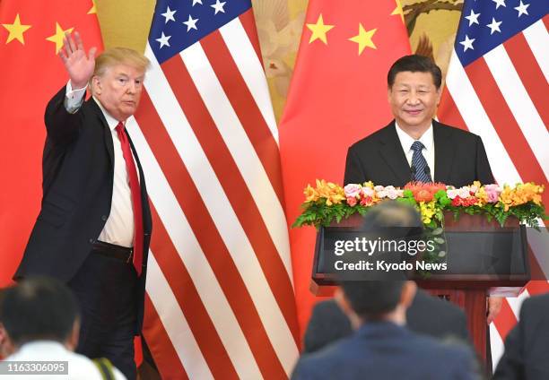 President Donald Trump and his Chinese counterpart Xi Jinping are pictured after a joint press conference at the Great Hall of the People in Beijing...