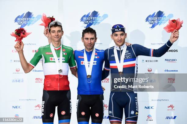 Silver medalist Davide Formolo of Italy, gold medalist Diego Ulissi of Italy and bronze medalist Nans Peters of France pose during the medal ceremony...