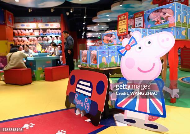 In this file photo taken on January 25 a billboard of Peppa Pig is displayed at a toy store in Beijing. - US toymaker Hasbro announced on August 22...