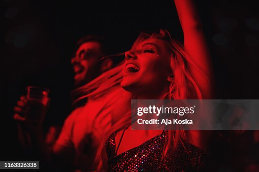 Young couple dancing at music festival. Young couple dancing at music festival.