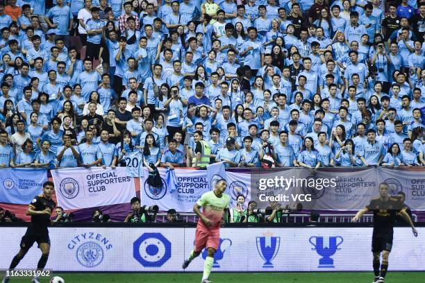 Fans of Manchester City cheer during the Premier League Asia Trophy final match between Manchester City and Wolverhampton Wanderers at Hongkou...