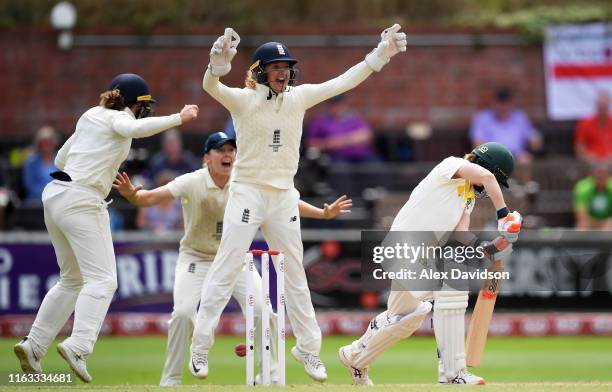 Sarah Taylor, Tammy Beaumont and Heather Knight of England celebrate the wicket of Racheal Haynes of Australia during Day Four of the Kia Women's...