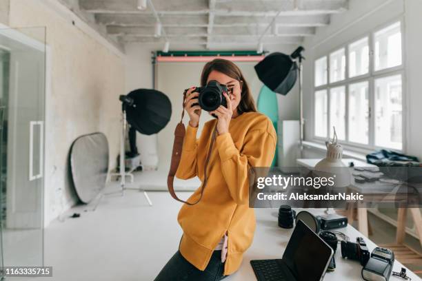 fotograaf werkzaam in een studio - females photos stockfoto's en -beelden