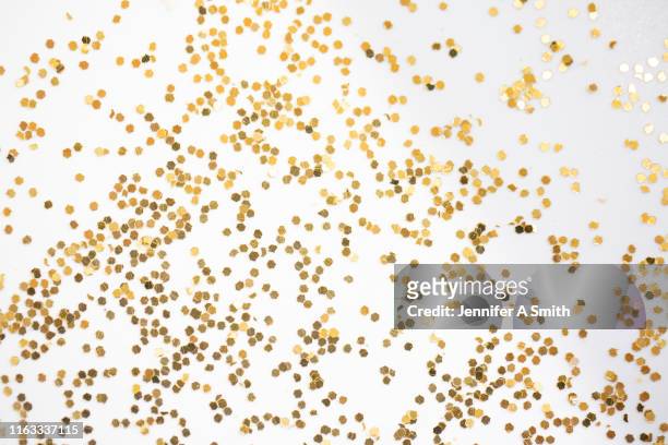 gold glitter - confetti gold stock pictures, royalty-free photos & images
