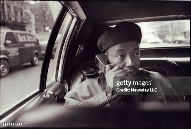 Rap music mogul Russell Simmons talks on the telephone in the back seat of a car in Manhattan on his way uptown to a meeting with Quincy Jones on...