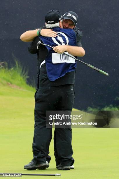 Open Champion Shane Lowry of Ireland celebrates with caddie Bo Martin on the 18th green during the final round of the 148th Open Championship held on...