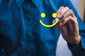 Conceptual the customer responded to the survey. The client using digital pen white happy face smile icon. Depicts that customer is very satisfied. Service experience and satisfaction concept.