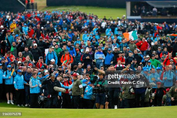 Open Champion Shane Lowry of Ireland celebrates on the 18th green during the final round of the 148th Open Championship held on the Dunluce Links at...