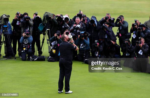 Photographers surround Open Champion Shane Lowry of Ireland as he celebrates with the Claret Jug on the 18th green during the final round of the...