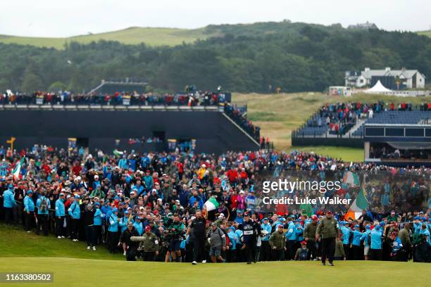 General view as Shane Lowry of Ireland walks onto the 18th green during the final round of the 148th Open Championship held on the Dunluce Links at...