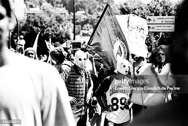 Supporters of anti-globalization movement wear masks during a protest against the 27th G8 Summit In Genoa, on July 21, 2001 in Genoa, Italy. Hundreds...