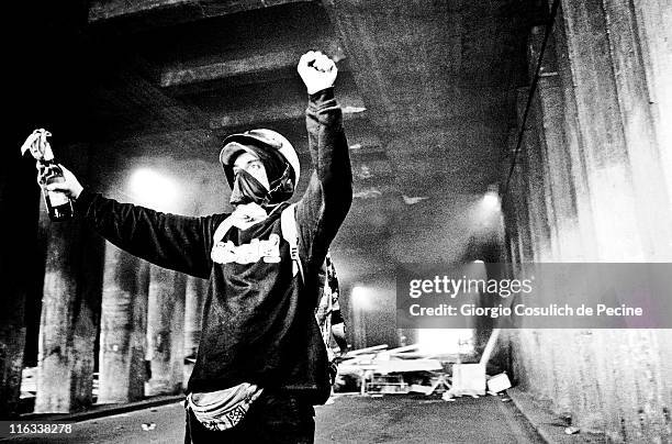 An activists of the anti-globalization movement shows a molotov cocktail during a protest against the 27th G8 Summit In Genoa, on July 21, 2001 in...