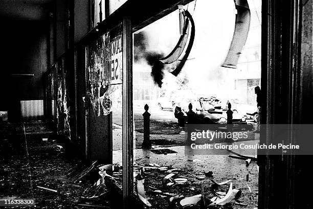 Bank on fire after clashes between police and activists of the anti-globalization movement during a protest against the 27th G8 Summit In Genoa, on...