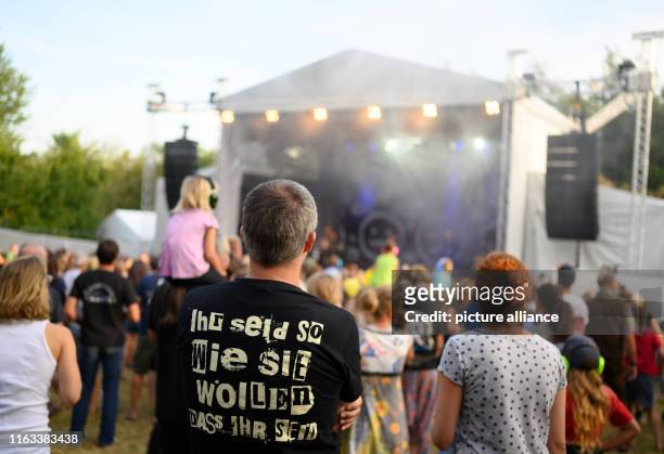 August 2019, Mecklenburg-Western Pomerania, Jamel: "You are as they want you to be" is written on a T-shirt of a visitor of the 13th...