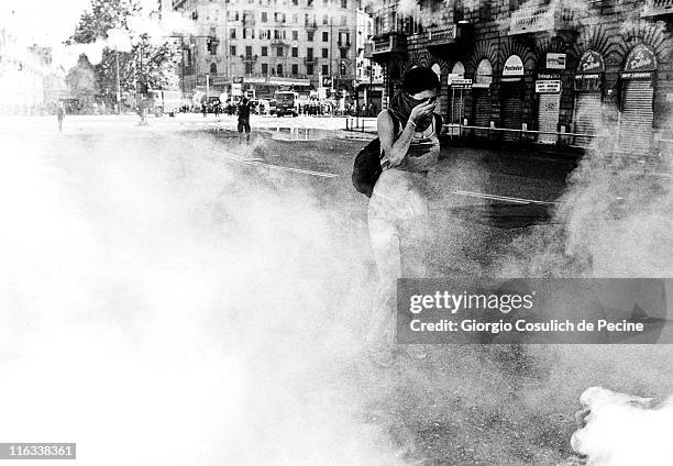 Woman walks through a curtain of tear gas during a protest against the 27th G8 Summit In Genoa, on July 21, 2001 in Genoa, Italy. Hundreds of...