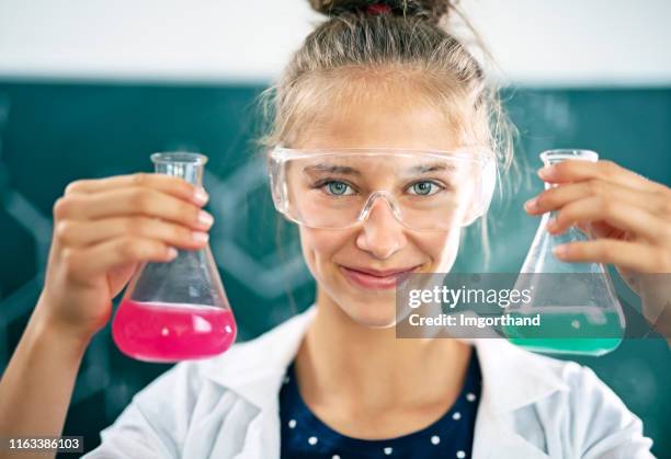 teenage girl enjoying chemistry lesson - chemistry class stock pictures, royalty-free photos & images