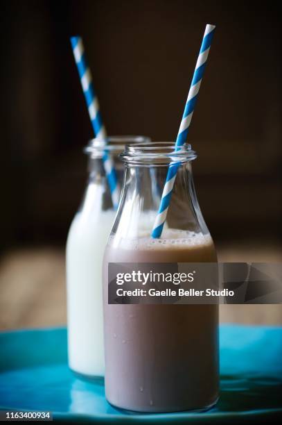 duo of milk and chocolate milk bottles with paper straws - chocolate milk bottle stock pictures, royalty-free photos & images