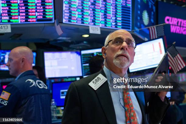 Trader Peter Tuchman works on the floor of the New York Stock Exchange on August 23, 2019 in New York City. The three major U.S. Stock indexes ended...