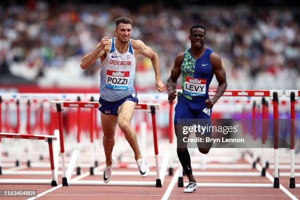 Andrew Pozzi of Great Britain and Ronald Levy of Jamaica compete in the Men's 110m Hurdles during Day Two of the Muller Anniversary Games IAAF...