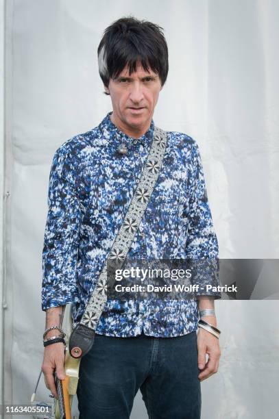 Johnny Marr poses for exclusive portrait session at Rock en Seine on August 23, 2019 in Saint-Cloud, France.