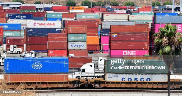 Container trucks arrive at the Port of Long Beach on August 23, 2019 in Long Beach, California. - President Donald Trump hit back at China on August...