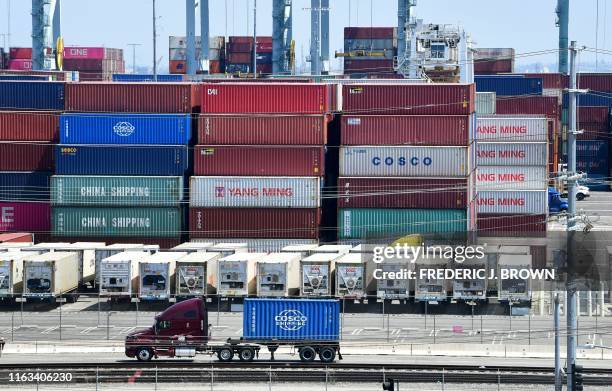 Container trucks arrive at the Port of Long Beach on August 23, 2019 in Long Beach, California. - President Donald Trump hit back at China on August...