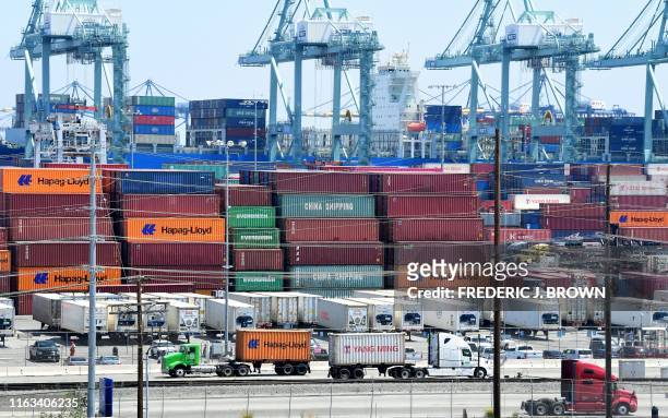 Container trucks arrive at the Port of Long Beach on August 23, 2019 in Long Beach, California. - President Donald Trump hit back at China on August...