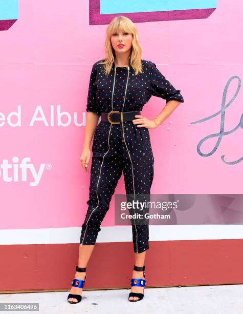 Taylor Swift poses in front of a mural introducing her latest album "Lover" on August 23, 2019 in in the Brooklyn borough of New York City.