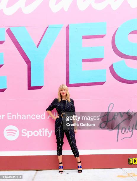 Taylor Swift poses in front of a mural introducing her latest album "Lover" on August 23, 2019 in in the Brooklyn borough of New York City.